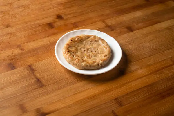 Chicken Patty served in plate isolated on wooden table top view of indian food