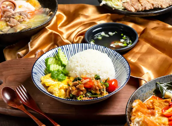 stock image Pork Rice with tomato, cucumber, fork and spoon served in dish isolated on wooden board side view of asian food