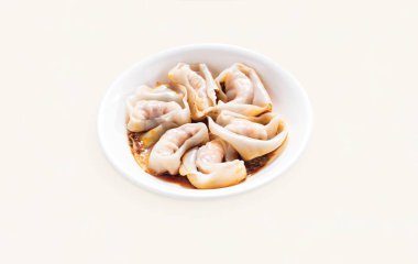 Dumplings, Wontons, Shao Mai, Shrimp and Pork Wontons with spicy Sauce served in plate isolated on grey background side view of hong kong food clipart