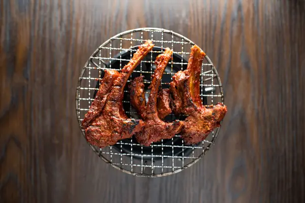 stock image Grilled Racks of Premium Lamb chops served in dish isolated on wooden table top view of korean food