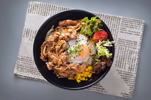 stock image Japanese beef hot spring egg rice bowl with corn and salad served in bowl isolated on napkin top view of chinese food on grey background