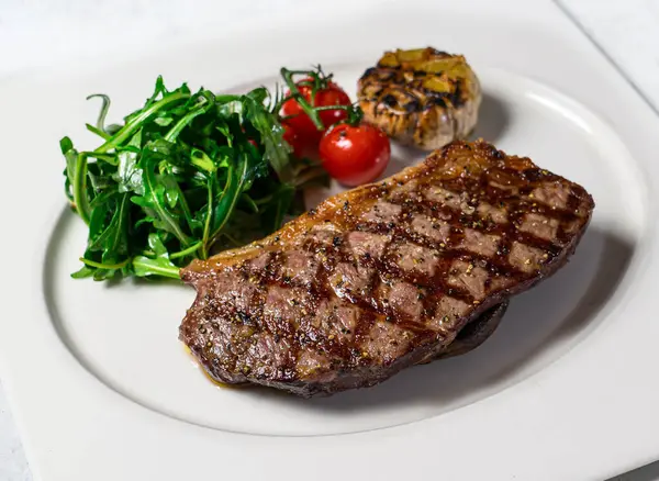 stock image Grilled Wagyu Sirloin Steak with cherry tomato served in dish isolated on background side view of italian food