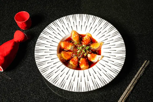 stock image Preserved Egg with pepper roast, sesame seeds, green onion, sauce and chopsticks served in dish on dark background top view of hong kong food