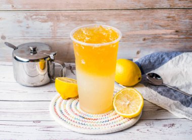 Iced Lemon Honey Tea with sugar pot and spoon served in disposable glass isolated on table side view of hong kong tea clipart