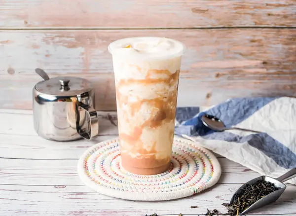 stock image Iced taro milk green tea with sugar pot and spoon served in disposable glass isolated on table side view of hong kong tea