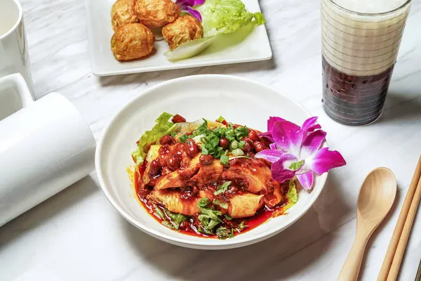 stock image Delicious saliva chicken with Dancing Sakura Shrimp, Fried squid balls, Taiwanese red bean ice tea served in dish isolated on marble background side view of taiwan food