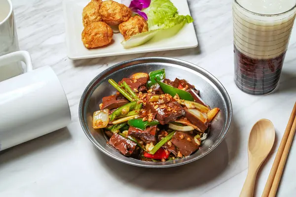 stock image Taiwanese fried duck blood, Fried squid balls, red bean ice tea served in dish isolated on marble background side view of taiwan food