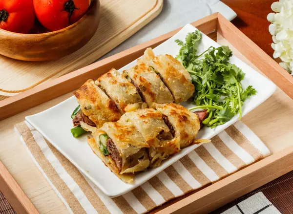 stock image Savory Beef Scallion Pancakes or Beef Burrito in dish served in wooden tray side view of taiwan food