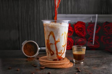 Indulgently Iced Caramel Macchiato Coffee served in glass isolated on background side view of healthy and delicious beverage clipart