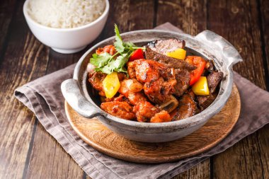 Domuz göbeği ve domuz kaburgası yahnisi ile buğulanmış pirinç çorbası peçete tarafındaki Hong Kong yemeklerini ahşap arka planda izole edilmiş şekilde servis edilir.