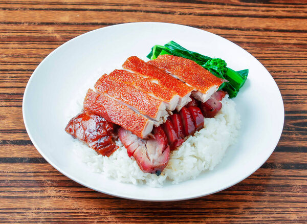 Barbecued Pork with Steamed Rice and Chinese Broccoli in plate on wooden table side view of Char Siu Rice