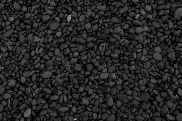 Beautiful black lava stone background texture, full frame shot of the black pebbles at Djupalonssandur beach, Iceland
