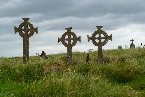 Picturesque gravestones with Celtic crosses at Cross Abbey graveyard, Mullet Peninsula, County Mayo, Ireland
