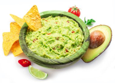 Guacamole sauce and tortilla chips, popular Mexican food  top view on white background.  clipart