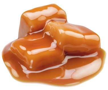 Beyaz zemin üzerinde erimiş karamel kaplı karamel şekerler..