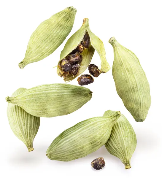 stock image Green cardamom pods and seeds levitating in air on white background. 