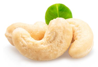 Beyaz arka planda yeşil yapraklı çiğ fındık ya da kaju çekirdeği.. 