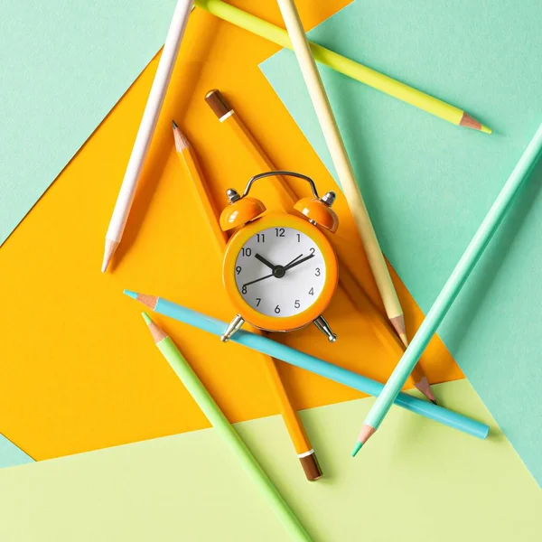 stock image Back to school, education and work concept. Stationery for learning (study) and alarm clock on mint yellow background. View from above, top view. Wake up time.