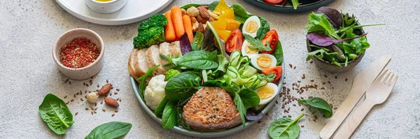 Vegetable plate with meat, fish and eggs. Complete diet for the day. Time to eat healthy foods. Eating by the hour. Health concept, copy space