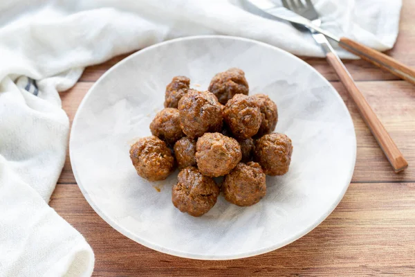 Stock image Baked homemade meatballs on wood floor. Local name misket kofte. close up