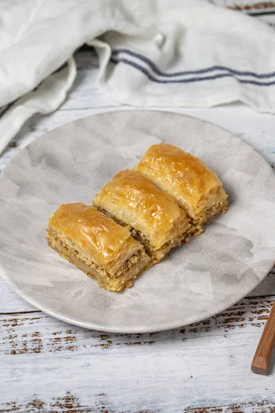 Stock image Walnut baklava on a white wooden background. Turkish cuisine delicacies. Turkish baklava. close up