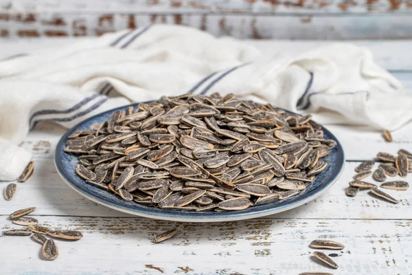 Sunflower seeds on wood background. Salted sunflower seeds. Healthy food. close up