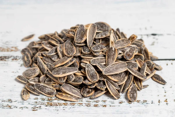 Sunflower seeds on wood background. Salted sunflower seeds. Healthy food. close up