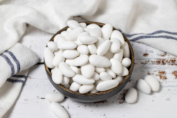 stock image Almond candy. Sugared almonds on a white wood background. close-up . local name badem sekeri