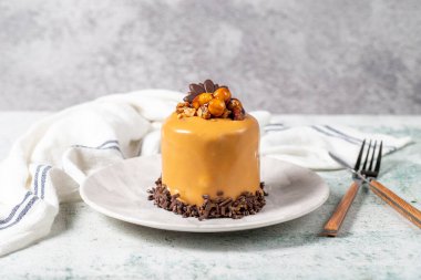 Caramel cake on a gray background. Chocolate and hazelnut cake. Bakery desserts. close up