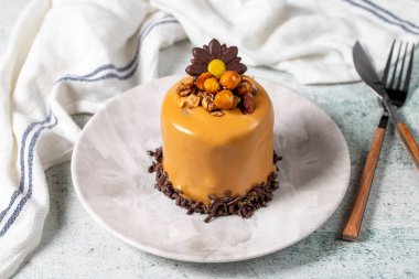 Caramel cake on a gray background. Chocolate and hazelnut cake. Bakery desserts. close up