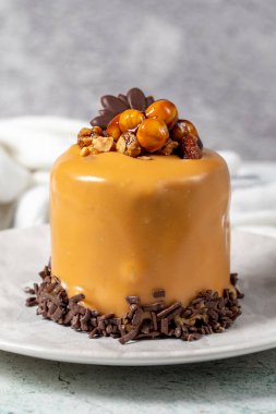 Caramel cake on a gray background. Chocolate and hazelnut cake. Bakery desserts. vertical view. close up