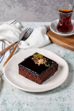 Chocolate slice cake on gray background. Chocolate moist cake. Bakery desserts. Vertical view. close up