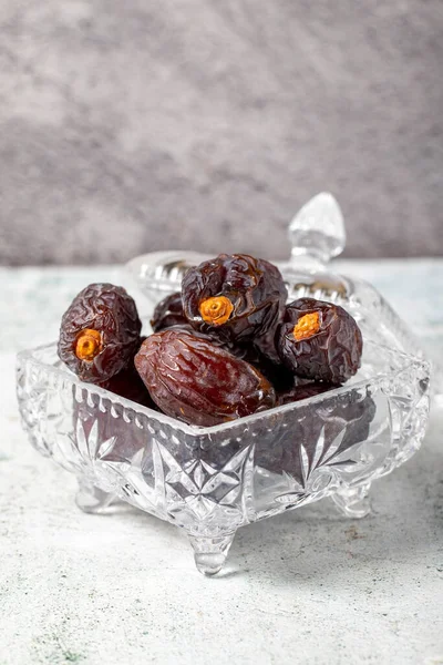Jerusalem date fruit on stone background. Dried Big date fruit in a glass bowl. Ramadan food. Healthy eating. close up