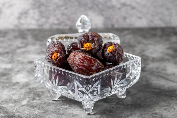Jerusalem date fruit on stone background. Dried Big date fruit in a glass bowl. Ramadan food. Healthy eating. close up