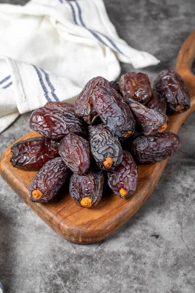 Jerusalem date fruit on stone background. Large date fruit on a wooden serving board. Ramadan food. Healthy eating. close up