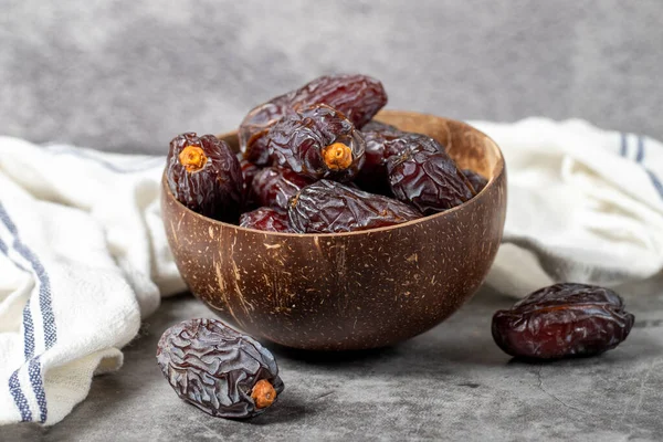 Jerusalem date fruit on stone background. Huge date fruit in a coconut bowl. Ramadan food. Healthy eating. close up