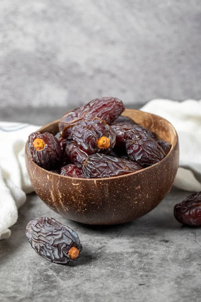 Jerusalem date fruit on stone background. Huge date fruit in a coconut bowl. Ramadan food. Healthy eating. close up