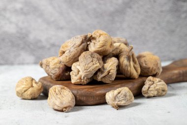 Dried figs on stone background. Sun-dried dried figs on a wooden serving board. Diet foods. close up
