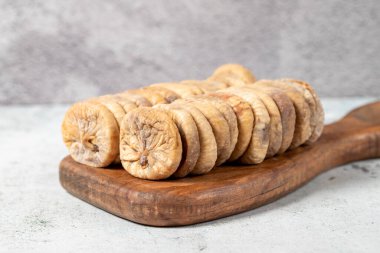 Dried figs on stone background. Special sun-dried dried figs on a wooden serving board. Diet foods. close up