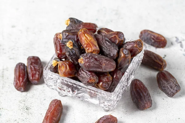Date fruit on stone background. Organic Medjoul dates in a glass bowl. Ramadan food. close up