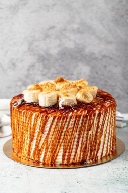 Caramel cake on a stone background. Fruit and caramel birthday cake. close up