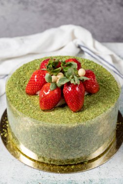 Strawberry cake on a stone background. Fruit and pistachio birthday cake. close up