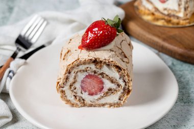 Strawberry Roll Cake. Log cake with cream and strawberries on a stone background. close up