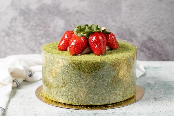 Strawberry cake on a stone background. Fruit and pistachio birthday cake. close up