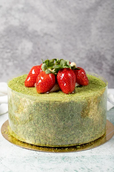 Strawberry cake on a stone background. Fruit and pistachio birthday cake. close up