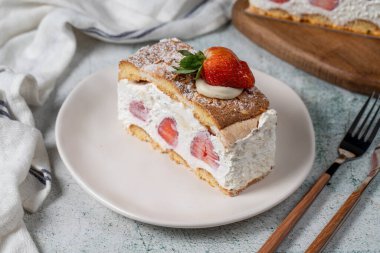 Strawberry and whipped cream cake. Strawberry and cream layer cake on plate. close up