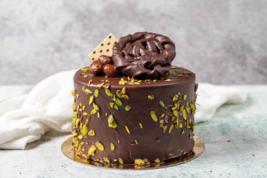 Chocolate and pistachio cake. Birthday or celebration cake on stone background. close up