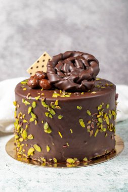 Chocolate and pistachio cake. Birthday or celebration cake on stone background. close up