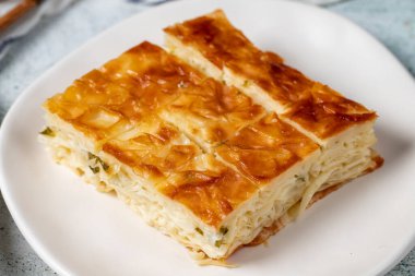 Turkish Su Boregi or Tabla borek with cheese. Turkish Patty on stone background. Close up