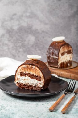 Layered Chocolate Cake on a Stone Background. A slice of delicious portion chocolate cake. close up